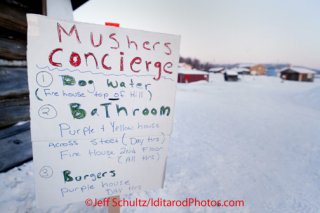 Sunday March 11, 2012   A sign for mushers information outside the community center at the Kaltag checkpoint informs mushers of needed information. Iditarod 2012.