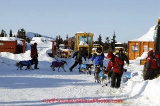 Sunday March 11, 2012  Volunteers help Aaron Burmeister do a u-turn to park his team after arriving at Elim. Iditarod 2012.