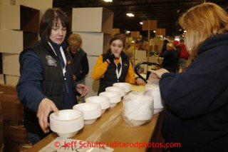 Friday, February 15, 2013.   Volunteer Teri Paton (L) and other volunteers count styrofoam bowls to be sent to out to the 22 checkpoints along the Iditarod trail during the 