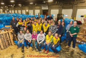 A team of volunteers bag over 1600 bales of straw at Airland Transport for use by the mushers and dogs at the 20+ checkpoints along the trail. Thursday February 12, 2015 prior to Iditarod 2015.(C) Jeff Schultz/SchultzPhoto.com - ALL RIGHTS RESERVEDDUPLICATION PROHIBITED WITHOUT PERMISSION
