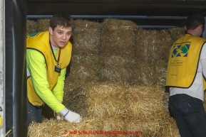 A team of volunteers bag over 1600 bales of straw at Airland Transport for use by the mushers and dogs at the 20+ checkpoints along the trail. Thursday February 12, 2015 prior to Iditarod 2015.(C) Jeff Schultz/SchultzPhoto.com - ALL RIGHTS RESERVEDDUPLICATION PROHIBITED WITHOUT PERMISSION
