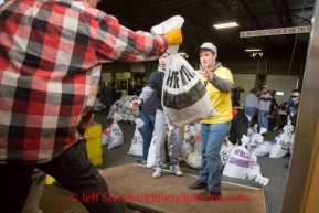 At the Airland Transport's sort facility, volunteers sort, weigh and tag musher food drop bags that are headed out for the 20+ checkpoints on Wednesday February 12, 2014.  PHOTO BY JEFF SCHULTZ/IDITARODPHOTOS.COM  USE ONLY WITH PERMISSION