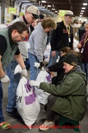 At the Airland Transport's sort facility, volunteers sort, weigh and tag musher food drop bags that are headed out for the 20+ checkpoints on Wednesday February 12, 2014.  PHOTO BY JEFF SCHULTZ/IDITARODPHOTOS.COM  USE ONLY WITH PERMISSION