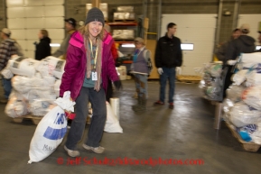 At the Airland Transport's sort facility, volunteers sort, weigh and tag musher food drop bags that are headed out for the 20+ checkpoints on Wednesday February 12, 2014.  PHOTO BY JEFF SCHULTZ/IDITARODPHOTOS.COM  USE ONLY WITH PERMISSION