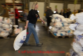 At the Airland Transport's sort facility, volunteers sort, weigh and tag musher food drop bags that are headed out for the 20+ checkpoints on Wednesday February 12, 2014.  PHOTO BY JEFF SCHULTZ/IDITARODPHOTOS.COM  USE ONLY WITH PERMISSION