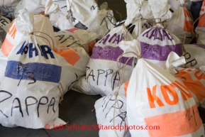 Musher food bags are waiting at the Airland Transport's sort facility as volunteers sort, weigh and tag musher food drop bags that are headed out for the 20+ checkpoints on Wednesday February 12, 2014.  PHOTO BY JEFF SCHULTZ/IDITARODPHOTOS.COM  USE ONLY WITH PERMISSION