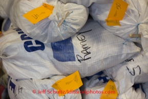 At the Airland Transport's sort facility, volunteers sort, weigh and tag musher food drop bags that are headed out for the 20+ checkpoints on Wednesday February 12, 2014.  PHOTO BY JEFF SCHULTZ/IDITARODPHOTOS.COM  USE ONLY WITH PERMISSION