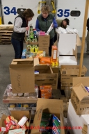 At the Airland Transport's sort facility, volunteers sort and package people food & accompanying supplies for the trail volunteers to eat during the race at the 20+ checkpoints on Friday February 14, 2014.  Iditarod Sled Dog Race 2014PHOTO BY JEFF SCHULTZ/IDITARODPHOTOS.COM  USE ONLY WITH PERMISSION