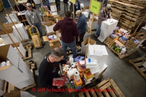 At the Airland Transport's sort facility, volunteers sort and package people food & accompanying supplies for the trail volunteers to eat during the race at the 20+ checkpoints on Friday February 14, 2014.  Iditarod Sled Dog Race 2014PHOTO BY JEFF SCHULTZ/IDITARODPHOTOS.COM  USE ONLY WITH PERMISSION