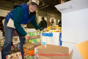 At the Airland Transport's sort facility, volunteers sort and package people food & accompanying supplies for the trail volunteers to eat during the race at the 20+ checkpoints on Friday February 14, 2014.  Iditarod Sled Dog Race 2014PHOTO BY JEFF SCHULTZ/IDITARODPHOTOS.COM  USE ONLY WITH PERMISSION