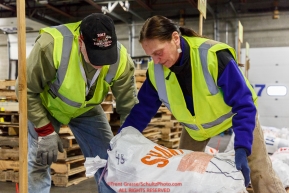 Iditarod volunteers Sylvia Iellaro and Dan Paige organize and stack the mushers food bags destined for the checkpoints on the 2017 Iditarod at the Airland Transport warehouse facilities in Anchorage Alaska.