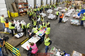 Iditarod volunteers unload, weigh, organize and stack the mushers food bags destined for the checkpoints on the 2017 Iditarod at the Airland Transport warehouse facilities in Anchorage Alaska.