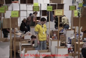 Friday, February 15, 2013.   Volunteers sort and pack an assortment of