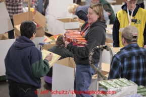 Friday, February 15, 2013.   Volunteers sort and pack an assortment of