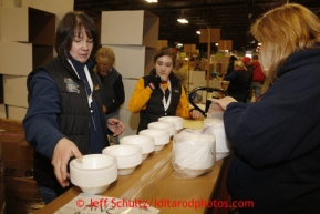 Friday, February 15, 2013.   Volunteer Teri Paton (L) and other volunteers count styrofoam bowls to be sent to out to the 22 checkpoints along the Iditarod trail during the