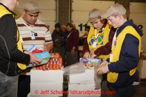 Friday, February 15, 2013.   Volunteers sort and pack an assortment of