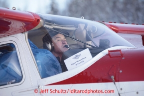 February 16, 2013  Volunteer Iditarod Air Force pilot Erin Marston taxis with a load bound for Finger Lake at the Willow airport as musher food, straw, HEET and people food is flown to the 4 checkpoints on the east side the Alaska Range. Iditarod 2013 Photo Copyright Jeff Schultz  -- Do not reproduce without written permission