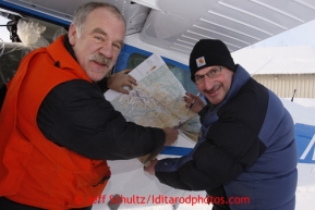 February 16, 2013   Co-chief pilot Phil Morgan (R) and pilot Greg Fischer talk over a sectional map prior to launch at the Willow airport during the first day of the