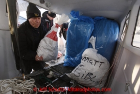 February 16, 2013  Iditarod Air Force pilot Mike Swalling loads his plane with straw and musher's food bags headed for the Skewnta checkpoint at the Willow airport on the first day of the