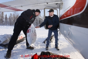 February 16, 2013  Volunteer Jason Spindler helps load volunteer Iditarod Air Force pilot Jerry Moriarity's  plane at the Willow airport as musher food, straw, HEET and people food is flown to the 4 checkpoints on the east side the Alaska Range. Iditarod 2013 Photo Copyright Jeff Schultz  -- Do not reproduce without written permission