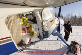 February 16, 2013  Volunteer Iditarod Air Force pilot,Dave Beckett readies his Helio Courier plane loaded with hay, HEET and musher's food bags bound for Rainy Pass at the Willow airport on the first day of the