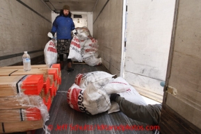 February 16, 2013  Volunteer Joe Alaniz unloads musher's food bags from a van at the Willow airport on the first day of the