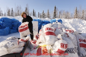 February 16, 2013  Volunteer Jennifer Ambrose piles musher food bags bound for Skwentna and which will be loaded into volunteer Iditarod Air Force planes at the Willow Airport during day one of the