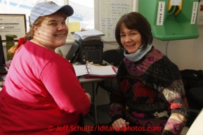 February 16, 2013  Logistics volunteers Brittany Hanson (L) and Teri Paton work the dispatch room at the Willow airport in support of the Iditarod Air Force during day one of the