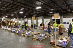 Iditarod volunteers sort and repackage human food and supplies for the trail volunteers to eat and use at each of the checkpoints on the 2018 Iditarod. The sorting is going on at the Airland Transport warehouse facilities in Anchorage Alaska on Friday  February 19, 2017.