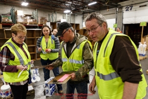Iditarod volunteers sort and repackage human food and supplies for the trail volunteers to eat and use at each of the checkpoints on the 2018 Iditarod. The sorting is going on at the Airland Transport warehouse facilities in Anchorage Alaska on Friday  February 19, 2017.
