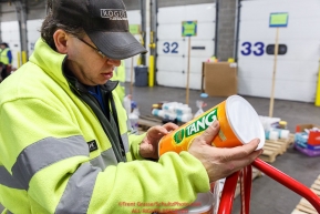 Iditarod volunteers examines a package of tang. The drink is an iconic part of the Iditarod sled dog race, at the Airland Transport warehouse facilities in Anchorage Alaska on Friday  February 19, 2017.