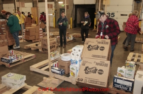 Friday February 17, 2012   Volunteers sort and package the human food and supplies for shipment to the 22 checkpoints on the Iditarod.  This food is donated by long-time sponsor Fred Meyer and will be consumed by the trail volunteers who man the chekpoints during the race.