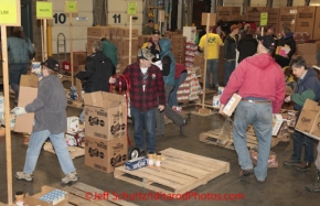 Friday February 17, 2012   Volunteers sort and package the human food and supplies for shipment to the 22 checkpoints on the Iditarod.  This food is donated by long-time sponsor Fred Meyer and will be consumed by the trail volunteers who man the chekpoints during the race.