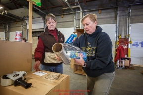 Iditarod volunteers sort and repackage human food and supplies for the trail volunteers to eat and use at each of the checkpoints on the 2017 Iditarod. The sorting is going on at the Airland Transport warehouse facilities in Anchorage Alaska on Friday  February 17, 2017.Photo by Jeff Schultz/SchultzPhoto.com  (C) 2017  ALL RIGHTS RESVERVED