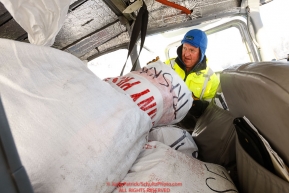 Pilot Russ Dunlap fills a plane with musher food bags as the Iditarod Air Force flies out food and supplies to checkpoints before the 2018 race from the Willow airport in Willow, Alaska Photo by Judy Patrick/SchultzPhoto.com  (C) 2018  ALL RIGHTS RESERVED