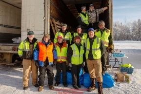 Logistics volunteers pose for a group photo on the day the Iditarod Air Force flies out food and supplies to checkpoints before the 2018 race from the Willow airport in Willow, Alaska Photo by Judy Patrick/SchultzPhoto.com  (C) 2018  ALL RIGHTS RESERVED