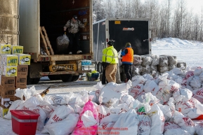 Race Marshal and Manager Mark Nordman unloads a bale of straw from van full of supplies as the Iditarod Air Force flies out food and supplies to checkpoints on Saturday February 17th before the 2018 race from the Willow airport in Willow, Alaska Photo by Judy Patrick/SchultzPhoto.com  (C) 2018  ALL RIGHTS RESERVED