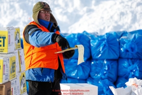 Logistics volunteer Chris Blankenship keeps track of supplies as the Iditarod Air Force flies out food and supplies to checkpoints on Saturday February 17th before the 2018 race from the Willow airport in Willow, Alaska Photo by Judy Patrick/SchultzPhoto.com  (C) 2018  ALL RIGHTS RESERVED