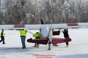 Pilots move a plane as the Iditarod Air Force flies out food and supplies to checkpoints on Saturday February 17th  before the 2018 race from the Willow airport in Willow, Alaska Photo by Judy Patrick/SchultzPhoto.com  (C) 2018  ALL RIGHTS RESERVED