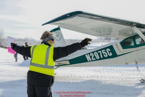 Load coordinator Leslie Washburn marshals in a plane as the Iditarod Air Force flies out food and supplies to checkpoints on Saturday February 17th before the 2018 race from the Willow airport in Willow, Alaska Photo by Judy Patrick/SchultzPhoto.com  (C) 2018  ALL RIGHTS RESERVED