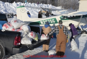 Saturday February 18, 2012  Volunteers move musher food bags toward pilot Danny Davidson's plane at the Willow airport as the straw, musher food bags, lathe, people food and supplies begin to be flown out by the Iditarod volunteer Air Force  to checkpoints along the trail.