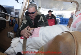 Saturday February 18, 2012   Volunteer pilot Danny Davidson straps his load of dog food down at the Willow airport as the straw, musher food bags, lathe, people food and supplies begin to be flown out by the Iditarod volunteer Air Force  to checkpoints along the trail.