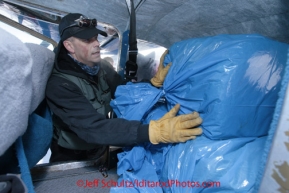 Saturday February 18, 2012  Pilot Udo Casee loads his Cessna 170 with straw at the Willow airport as the straw, musher food bags, lathe, people food and supplies begin to be flown out by the Iditarod volunteer Air Force  to checkpoints along the trail.