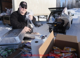 Saturday February 18, 2012   Long-time volunteer Larry Cheso begins to prepare an outdoor barbecue lunch for pilots and support at the Willow airport as the straw, musher food bags, lathe, people food and supplies begin to be flown out by the Iditarod volunteer Air Force  to checkpoints along the trail.