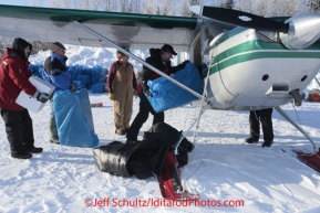 Saturday February 18, 2012  Volunteers Tim Leach, Chris Blankenship, Larry Schmidt and Al Kiefer help load Greg Miller's plane at the Willow airport as the straw, musher food bags, lathe, people food and supplies begin to be flown out by the Iditarod volunteer Air Force  to checkpoints along the trail.