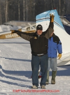 Saturday February 18, 2012   Chief pilot Bert Hanson signals a pilot to a parking spot at the Willow airport as the straw, musher food bags, lathe, people food and supplies begin to be flown out by the Iditarod volunteer Air Force  to checkpoints along the trail.