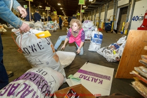 Iditarod musher DeeDee Jonrowe repackages some of her drop bags during the musher food drop at Airland Transport warehouse in Anchorage on Wednesday February 18th prior to Iditarod 2015.(C) Jeff Schultz/SchultzPhoto.com - ALL RIGHTS RESERVEDDUPLICATION PROHIBITED WITHOUT PERMISSION