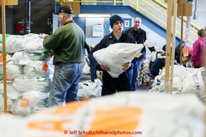 A team of volunteers unload, sort, weigh, tag and palletize thousands of musher food drop bags at Airland Transport warehouse in Anchorage on Wednesday February 18th prior to Iditarod 2015.(C) Jeff Schultz/SchultzPhoto.com - ALL RIGHTS RESERVEDDUPLICATION PROHIBITED WITHOUT PERMISSION