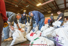A team of volunteers unload, sort, weigh, tag and palletize thousands of musher food drop bags at Airland Transport warehouse in Anchorage on Wednesday February 18th prior to Iditarod 2015.(C) Jeff Schultz/SchultzPhoto.com - ALL RIGHTS RESERVEDDUPLICATION PROHIBITED WITHOUT PERMISSION