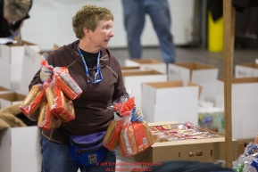 Volunteers sort and pack human food for the volunteers which will be working at the 20+ checkpoints durinig this year's 2016 Iditarod Race at the Airland Transport warehouse in Anchorage on Friday, February 19, 2016.